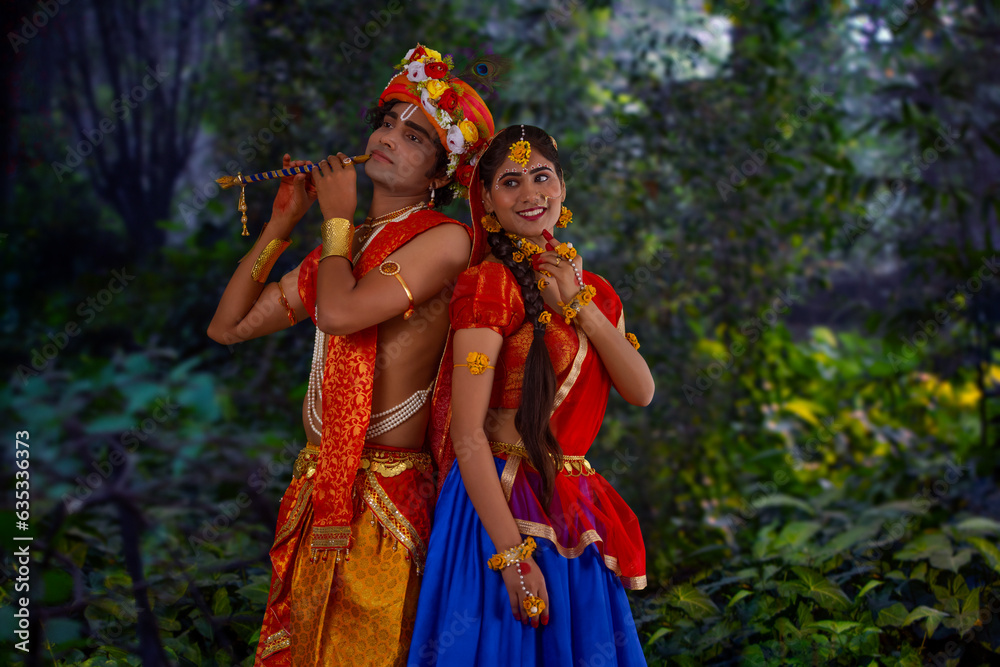 Young man and woman dressed up as Radha and Krishna and romancing on the occasion of Janmashtami Young man and woman dressed up as Radha and Krishna and romancing on the occasion of Janmashtami