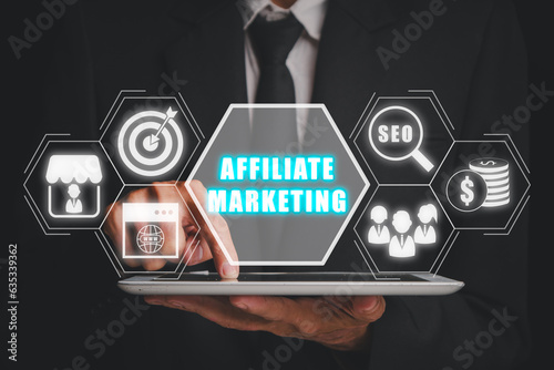 Affiliate marketing concept, Businessman working on tablet computer with affiliate marketing icon on virtual screen, Digital Marketing content planning advertising strategy. photo