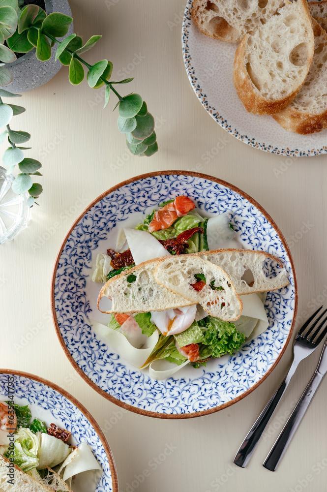 caesar salad with salmon. restaurant menu.