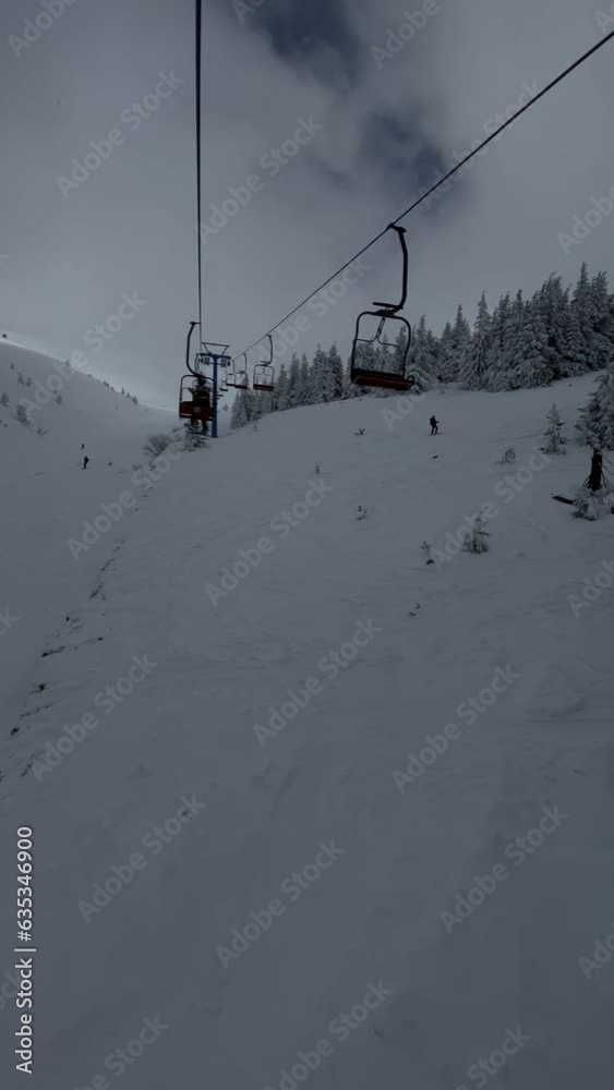 view of ski resort from chair lift at snowed powder day view of ski resort from chair lift at snowed powder day