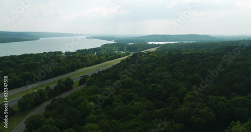 Scenic drive next to Arkansas river, aerial pan, dense woodland photo