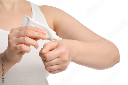 Woman applying ointment from tube onto her hand on white background, closeup