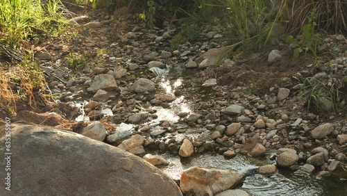 Natural Open Air Hot Springs, Steam is Coming from hot rocks and water surface. 4K Slowmotion travel destination concept footage. Norhern Thailand. photo