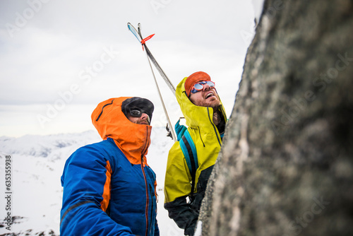 Skiers and climbers assess the final pitch, mountain summit