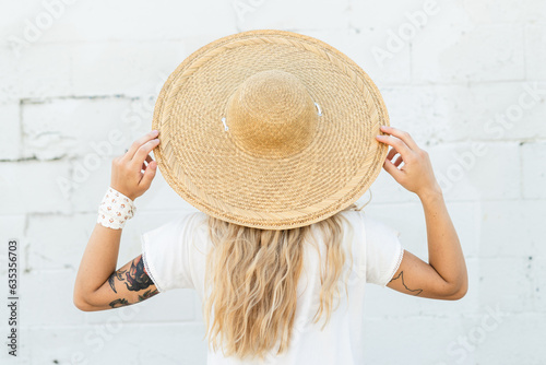 A woman wearing a large wicker hat photo