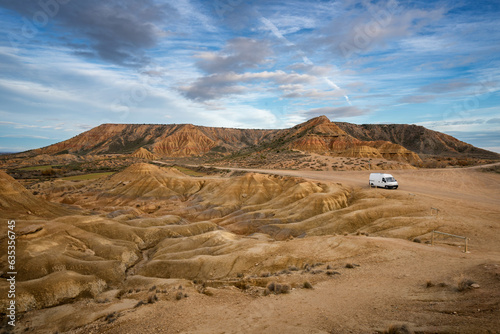 Camper van on Bardenas Reales desert landscape in Navarra, Spain photo