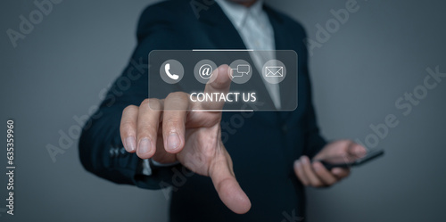 Businessman touching on virtual screen contact icons (email, address, live chat, telephone). Contact us or Customer support hotline.
