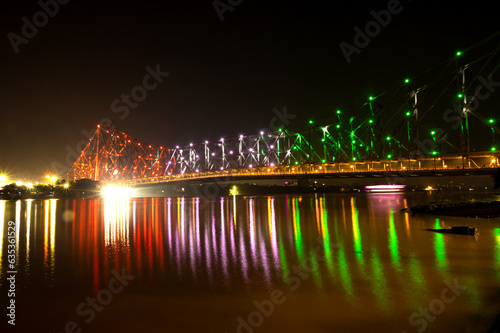 Howrah bridge - The historic cantilever bridge on the river Hooghly lit with tricolor of India on the occasion of Independence day of India. Howrah bridge is considered as the busiest bridge in India.