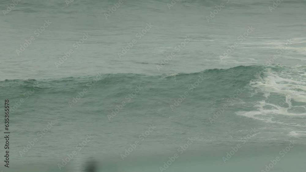 A bodyboarder passes over a wave as he heads out farther into sea. Located in Punta Hermosa beach. Located in Lima, Peru. A bodyboarder passes over a wave as he heads out farther into sea. Located in Punta Hermosa beach. Located in Lima, Peru.