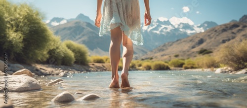 Woman traveler barefoot cooling feet on Mendoza River Argentina Composition with copy space photo