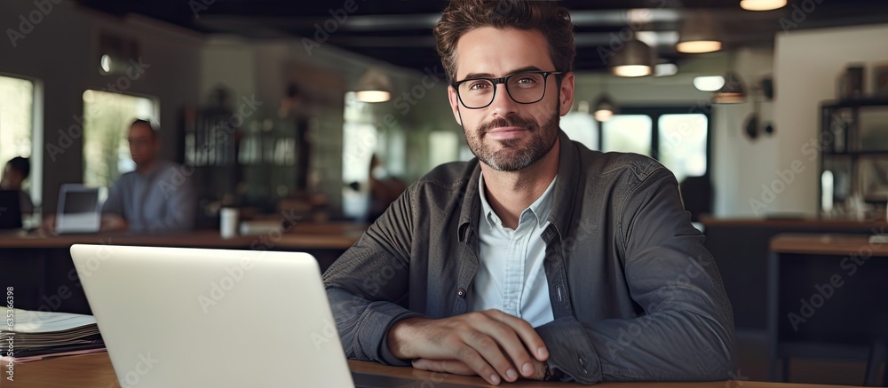 Happy freelancer man enjoying remote work and self employment smiling at camera Happy freelancer man enjoying remote work and self employment smiling at camera