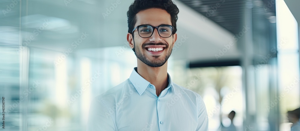 Young Arabian man in office confident wearing glasses smiling at camera Young Arabian man in office confident wearing glasses smiling at camera