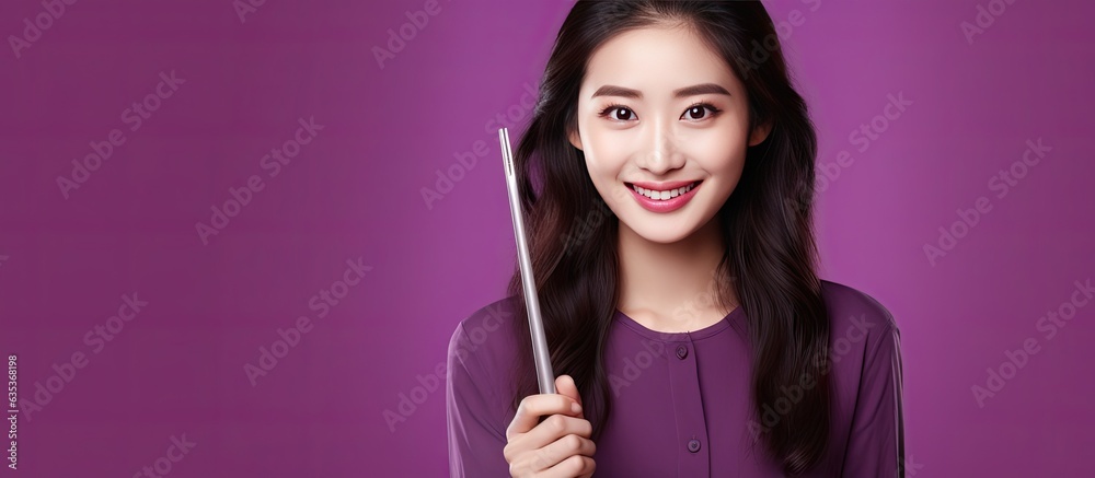 Smiling woman holds chopsticks in a portrait on purple background Smiling woman holds chopsticks in a portrait on purple background