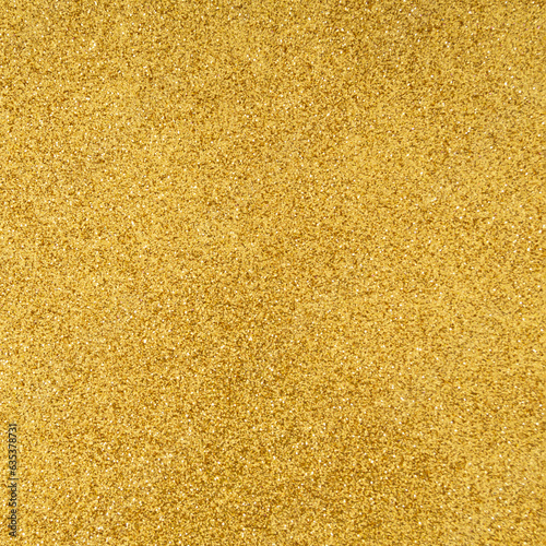 Trendy sparkly golden glitter texture background. Minimal background concept. Creative texture background idea. Flat lay, top of view.