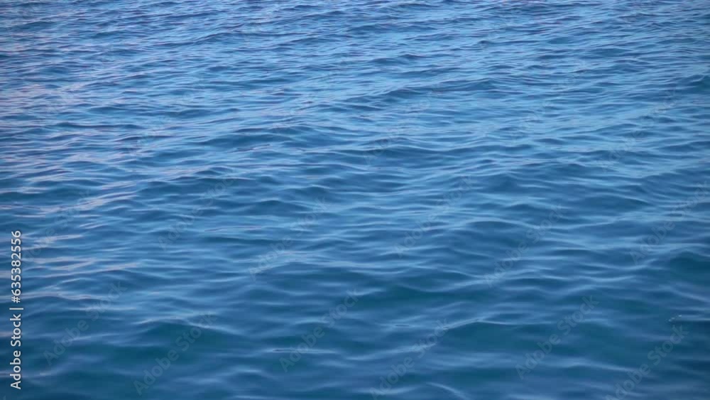Open water surface of the sea with small waves. Natural background with sun sparkles on the surface of the water. Meditation, relaxation, peace, tranquility Open water surface of the sea with small waves. Natural background with sun sparkles on the surface of the water. Meditation, relaxation, peace, tranquility