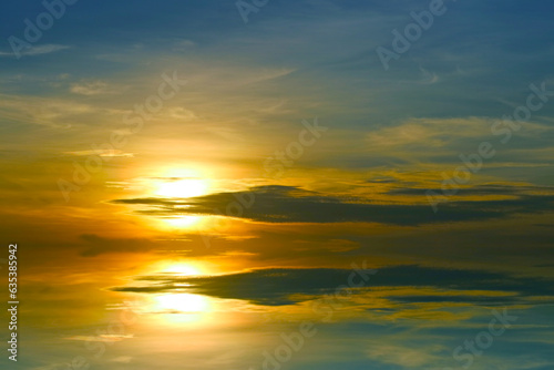 reflection sunset colorful dark blue orange sky and dark yellow cloud and sun lower left flame