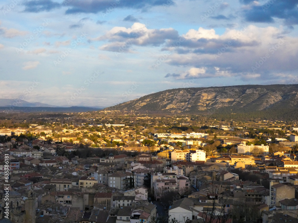 Photo on a spring evening of the town of Cavaillon in the Vaucluse in Provence in France, part of which is in the shade and the other lit by the sun