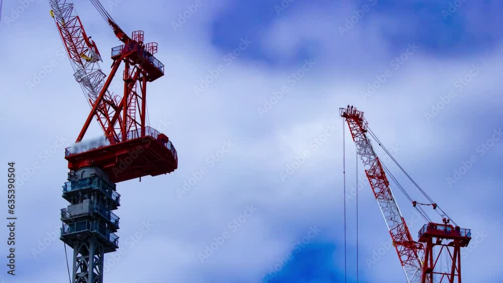 A timelapse of crane at the under construction in Tokyo telephoto shot panning A timelapse of crane at the under construction in Tokyo telephoto shot panning