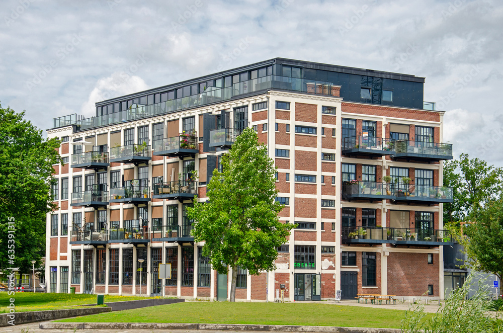 Enschede, The Netherlands, August 9, 2023: old textile mill in Roombeek neighbourhood converted to school and exhibition space with apartments