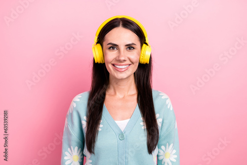 Portrait of lovely adorable girl wear flower print pullover listen favorite playlist in headphones isolated on pink color background