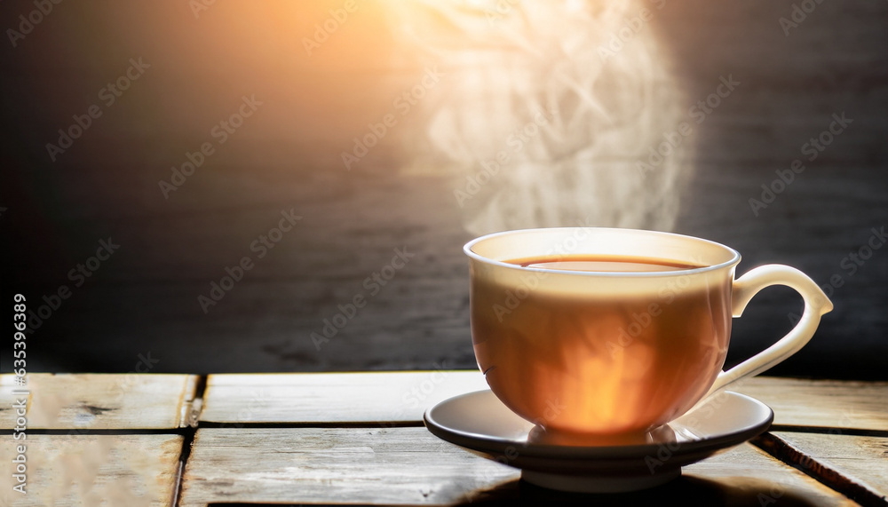 Hot teacup Placed on an old wooden table on a black background, the soft sunlight shone into a warm atmosphere. Hot teacup Placed on an old wooden table on a black background, the soft sunlight shone into a warm atmosphere.
