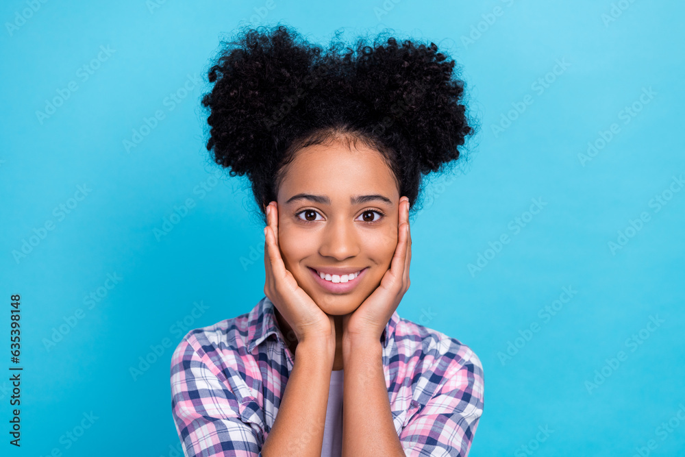 Photo of cheerful good mood girl with perming coiffure dressed checkered shirt hold palms on cheekbones isolated on blue color background