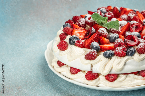 Pavlova dessert with layers of meringue and whipped cream with berries, Long banner format. top view
