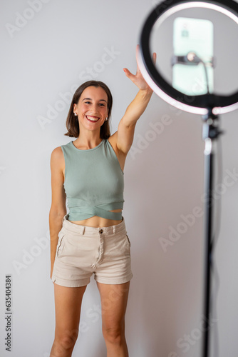 influencer girl. happy girl recording a video for social networks. He is waving at the camera