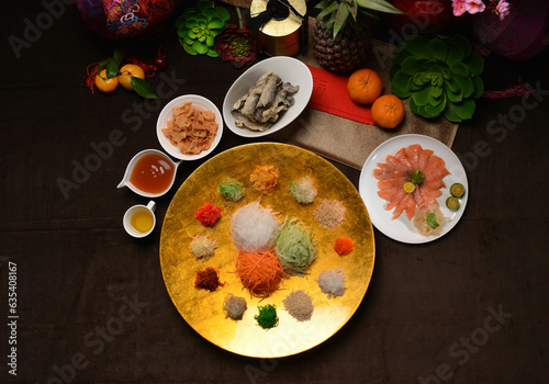 fresh colourful asian festive vegetables salad lo hei yu sheng with smoked salmon, fish skin, cookies and sweet spicy sauce buffet corner for chinese new year halal food menu for banquet restaurant