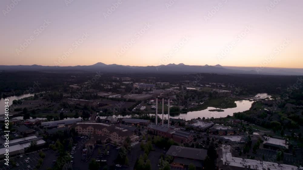 Bend Oregon Sunset - Left to right Panning Drone Shot of the Old Mill, Deschutes River, and Cascade Mountains (4K). Bend Oregon Sunset - Left to right Panning Drone Shot of the Old Mill, Deschutes River, and Cascade Mountains (4K).