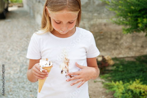 The child stained his clothes with ice cream. photo