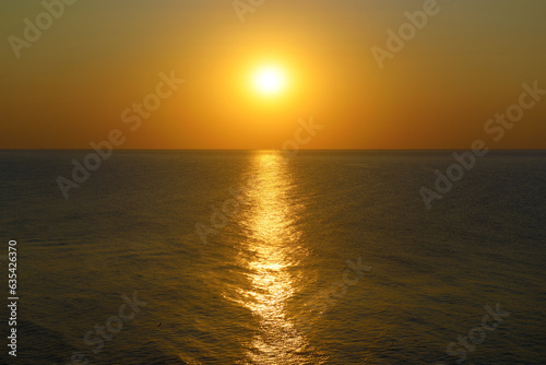 Sunset with sun path on surface of sea.