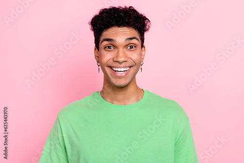 Photo of positive excited guy wear green t-shirt smiling white teeth isolated pink color background