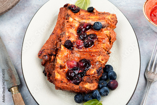 Grilled pork ribs with berry sauce.