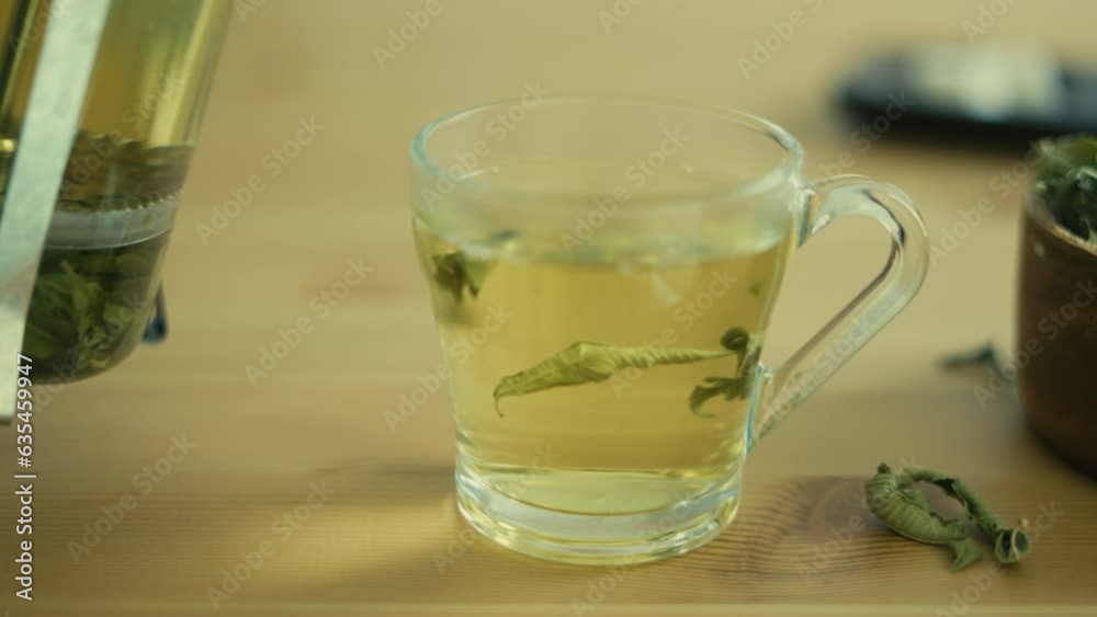 green tea mug over wooden table green tea mug over wooden table