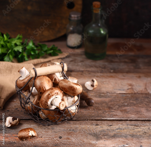 natural organic champignon mushrooms on a wooden table
