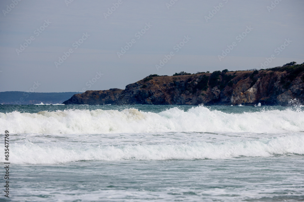 Abstract landscape with sea waves at the shore on a windy day.