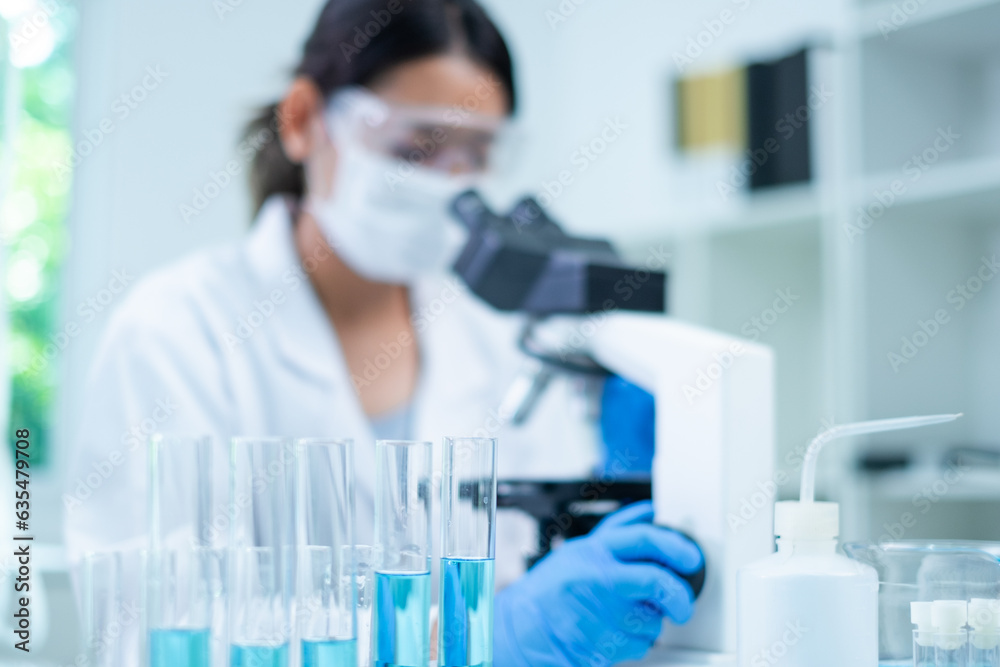Medical Research Laboratory. Female Scientist Using Microscope to analyze substance or liquid, virus. Professionals Working in Advanced Scientific Lab doing Medicine, Vaccine, Biotechnology test Medical Research Laboratory. Female Scientist Using Microscope to analyze substance or liquid, virus. Professionals Working in Advanced Scientific Lab doing Medicine, Vaccine, Biotechnology test