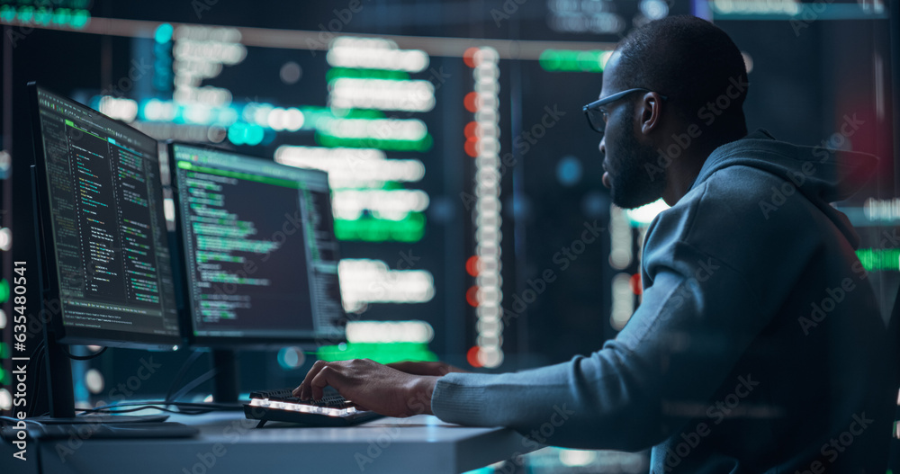 Black Male Programmer Working in Monitoring Room, Surrounded by Big Screens Displaying Lines of Programming Language Code. Portrait of Man Creating a Software. Abstract Futuristic Coding Concept Black Male Programmer Working in Monitoring Room, Surrounded by Big Screens Displaying Lines of Programming Language Code. Portrait of Man Creating a Software. Abstract Futuristic Coding Concept