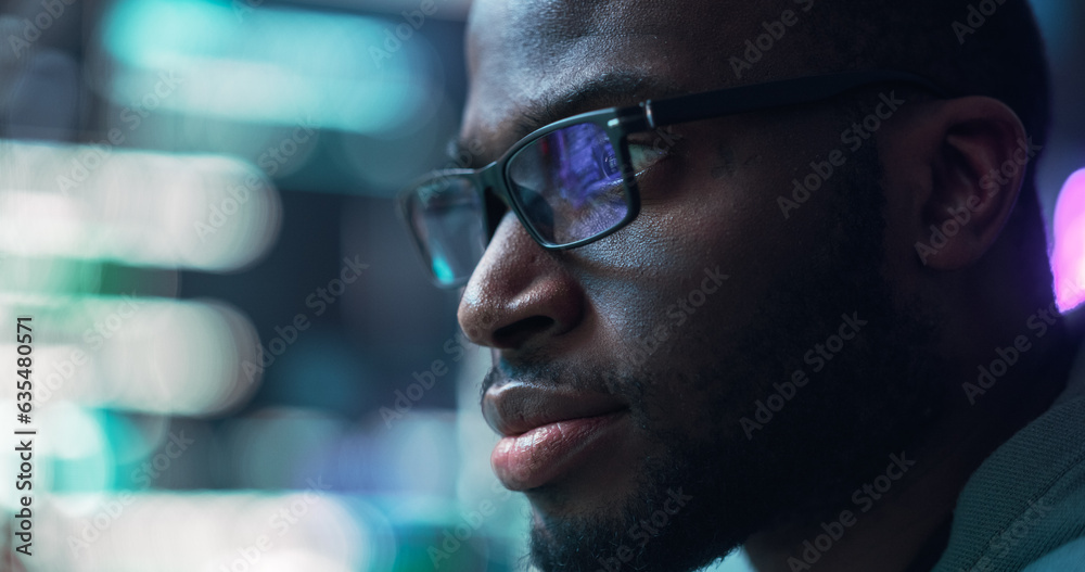 Close Up Portrait of Black Man Working on Computer, Lines of Code Language Reflecting on his Glasses. Male Programmer Developing New Software, Coding, Managing Cybersecurity Project Close Up Portrait of Black Man Working on Computer, Lines of Code Language Reflecting on his Glasses. Male Programmer Developing New Software, Coding, Managing Cybersecurity Project