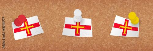 Guernsey flag pinned in cork board, three versions of Guernsey flag.