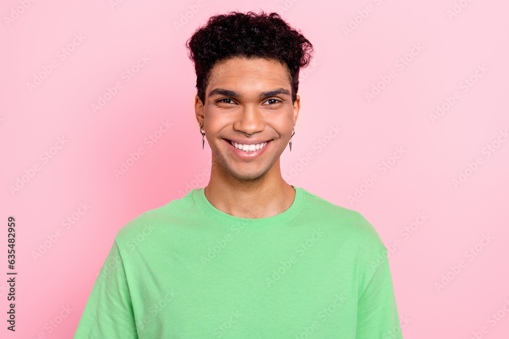 Photo of cheerful positive guy wear green t-shirt smiling white teeth isolated pink color background Photo of cheerful positive guy wear green t-shirt smiling white teeth isolated pink color background