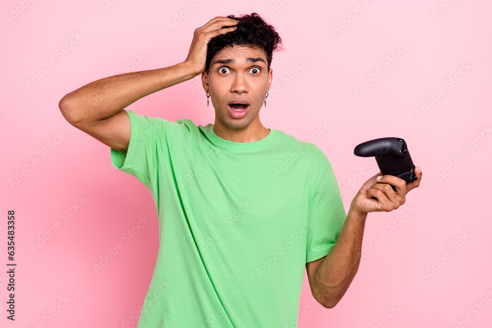 Photo of afraid stressed depressed guy player have fun free time play video game lost competition isolated on pink color background Photo of afraid stressed depressed guy player have fun free time play video game lost competition isolated on pink color background