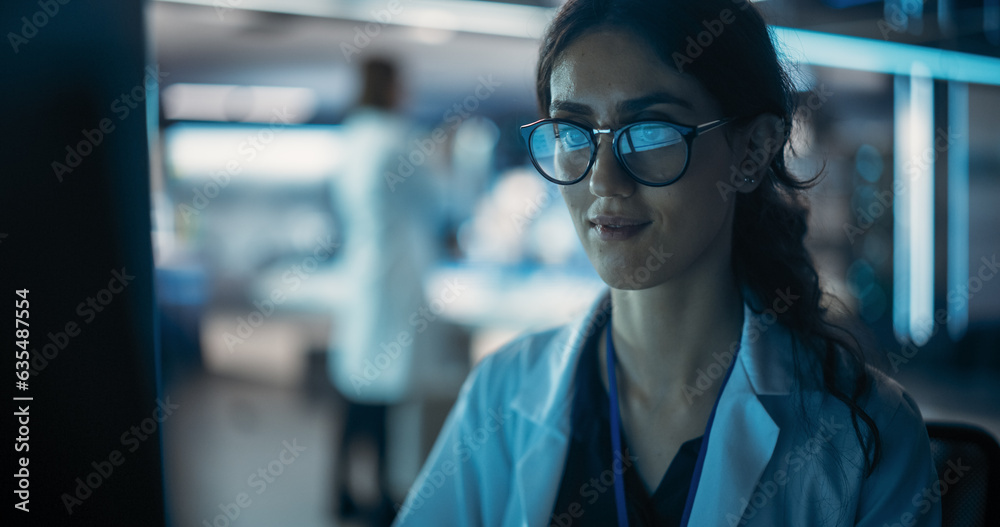 Portrait of a Professional Female Specialist Using Computer at Work in Research and Development Agency. Young Multiethnic Engineer, Developer or Scientist Working in Development Technology Office Portrait of a Professional Female Specialist Using Computer at Work in Research and Development Agency. Young Multiethnic Engineer, Developer or Scientist Working in Development Technology Office