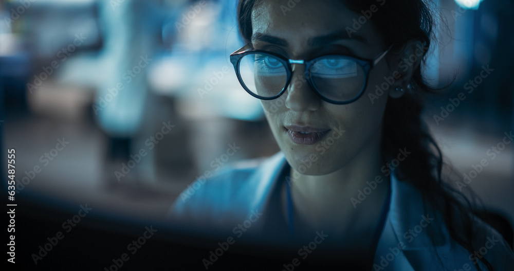 Portrait of Beautiful Multiethnic Woman Working on Computer with the Screen Reflecting in Her Glasses. Young Intelligent Female Scientist Working in Laboratory. Background with Technological Lights Portrait of Beautiful Multiethnic Woman Working on Computer with the Screen Reflecting in Her Glasses. Young Intelligent Female Scientist Working in Laboratory. Background with Technological Lights