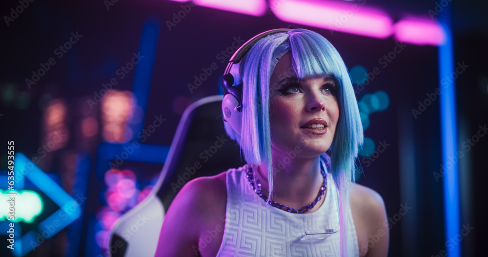 Stylish Streamer or Gamer with Blue Hair Chats with Internet Fans on Computer in Futuristic Cyber Technology Room. Footage for Social Media, Streaming, and Gaming Content Stylish Streamer or Gamer with Blue Hair Chats with Internet Fans on Computer in Futuristic Cyber Technology Room. Footage for Social Media, Streaming, and Gaming Content