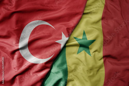 big waving national colorful flag of turkey and national flag of senegal .