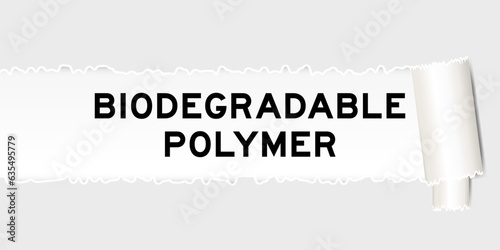 Ripped gray paper background that have word biodegradable polymer under torn part