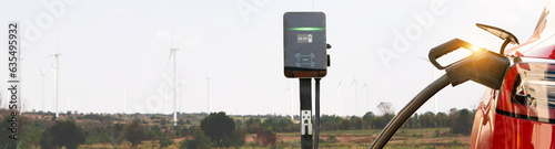 Electric car EV clean energy vehicle charging energy wind turbine station natural resources renewable wind energy in a wind farm : Generate electricity for charging stations environmentally friendly.