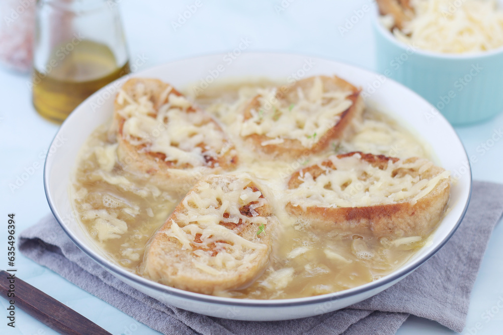 A ceramic bowl with French onion soup